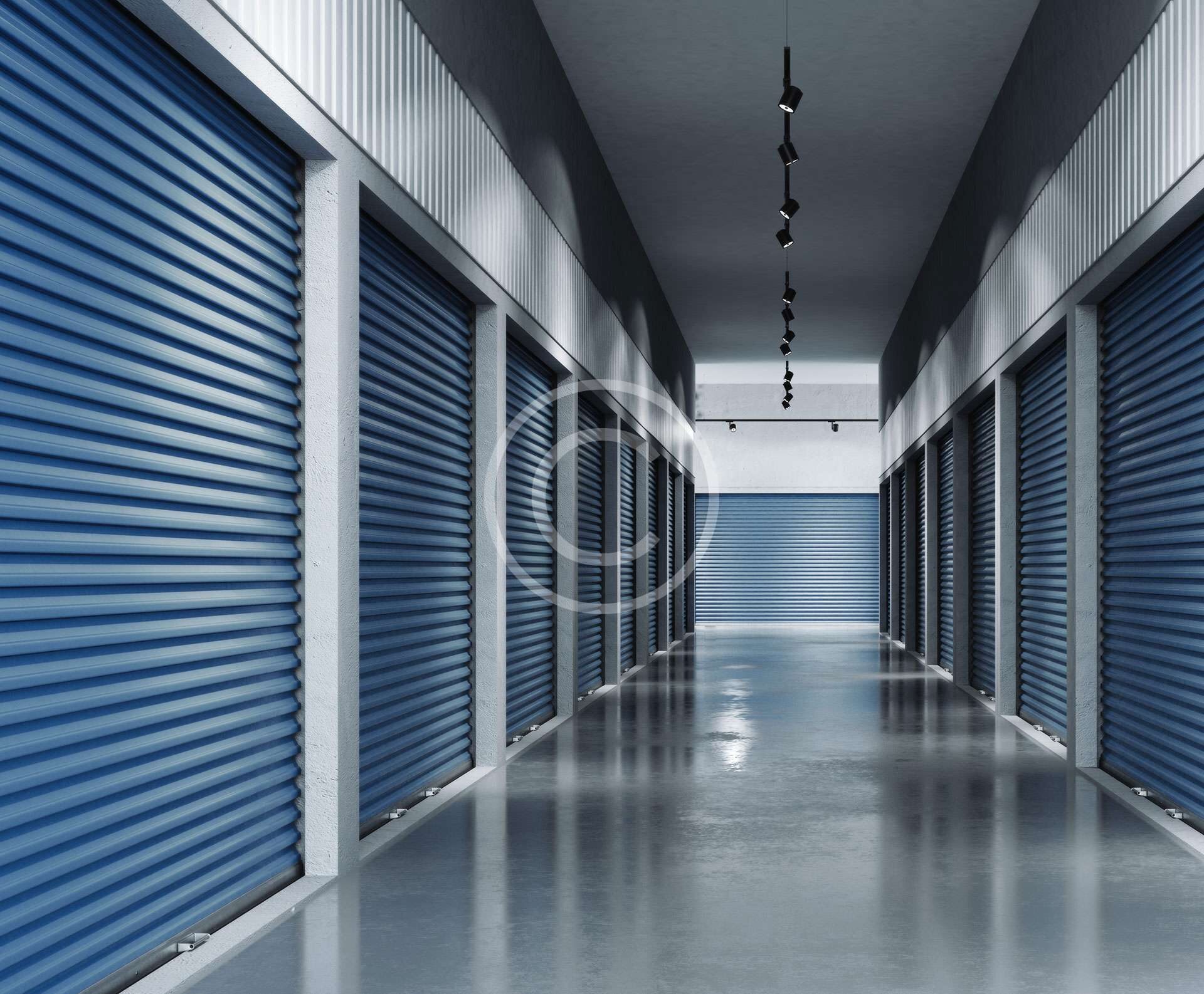 A clean, well-lit corridor with blue roll-up storage unit doors.