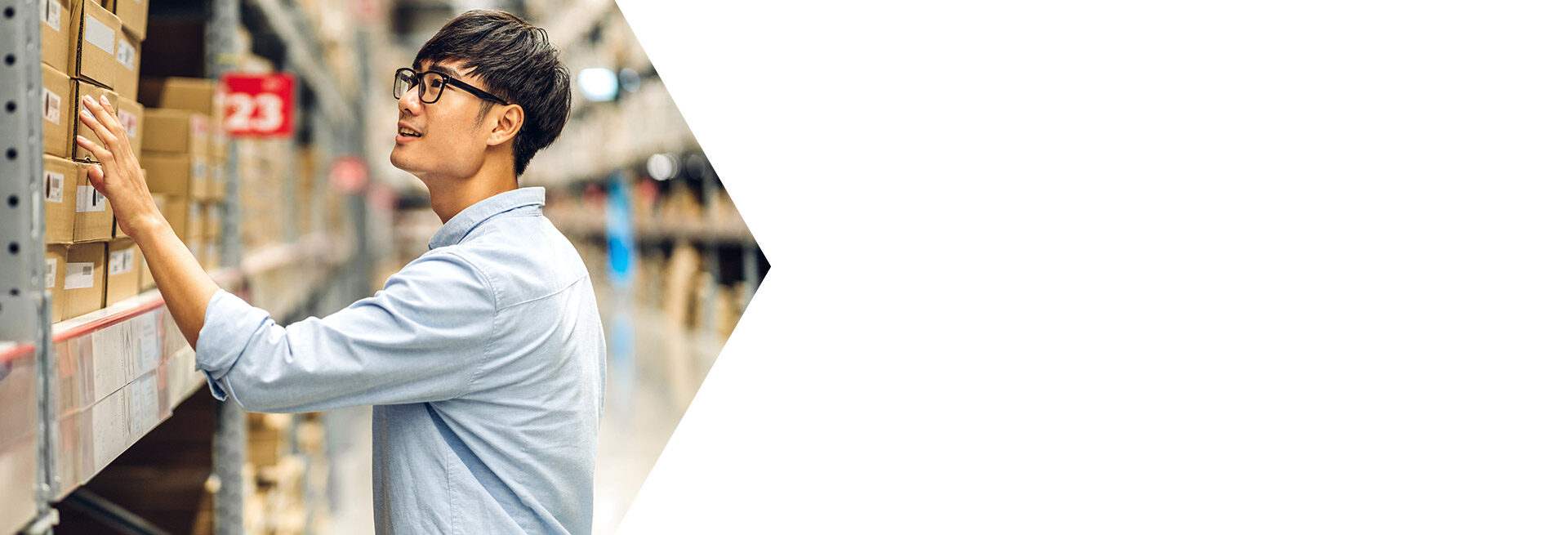 Man working on laptop in a modern office setting.