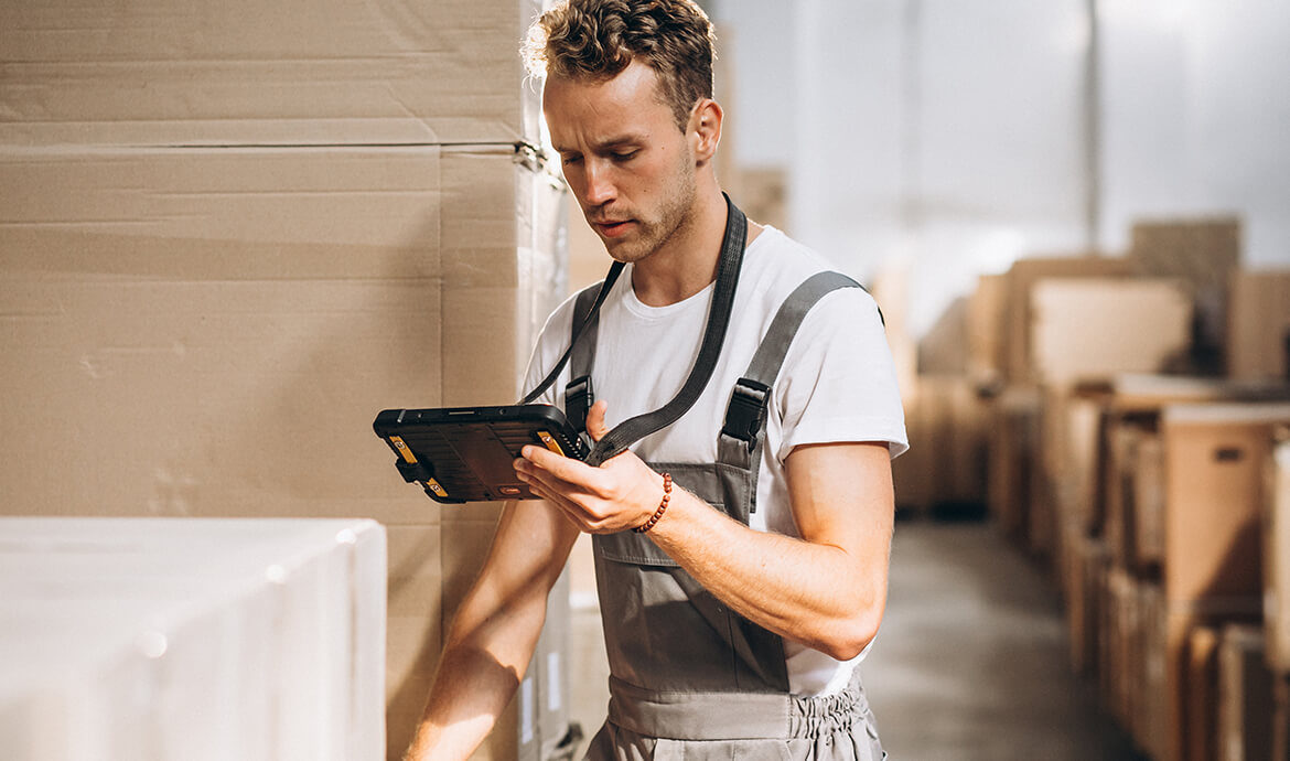 Worker using a tablet in a warehouse.