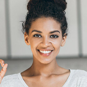Smiling woman with a friendly expression and curly hair.