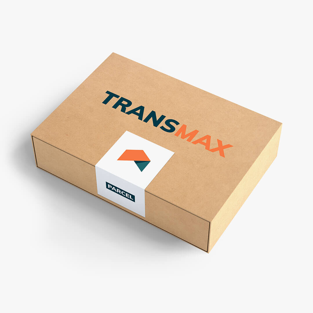 A cardboard box labeled TRANS MAX with a branded sticker.
