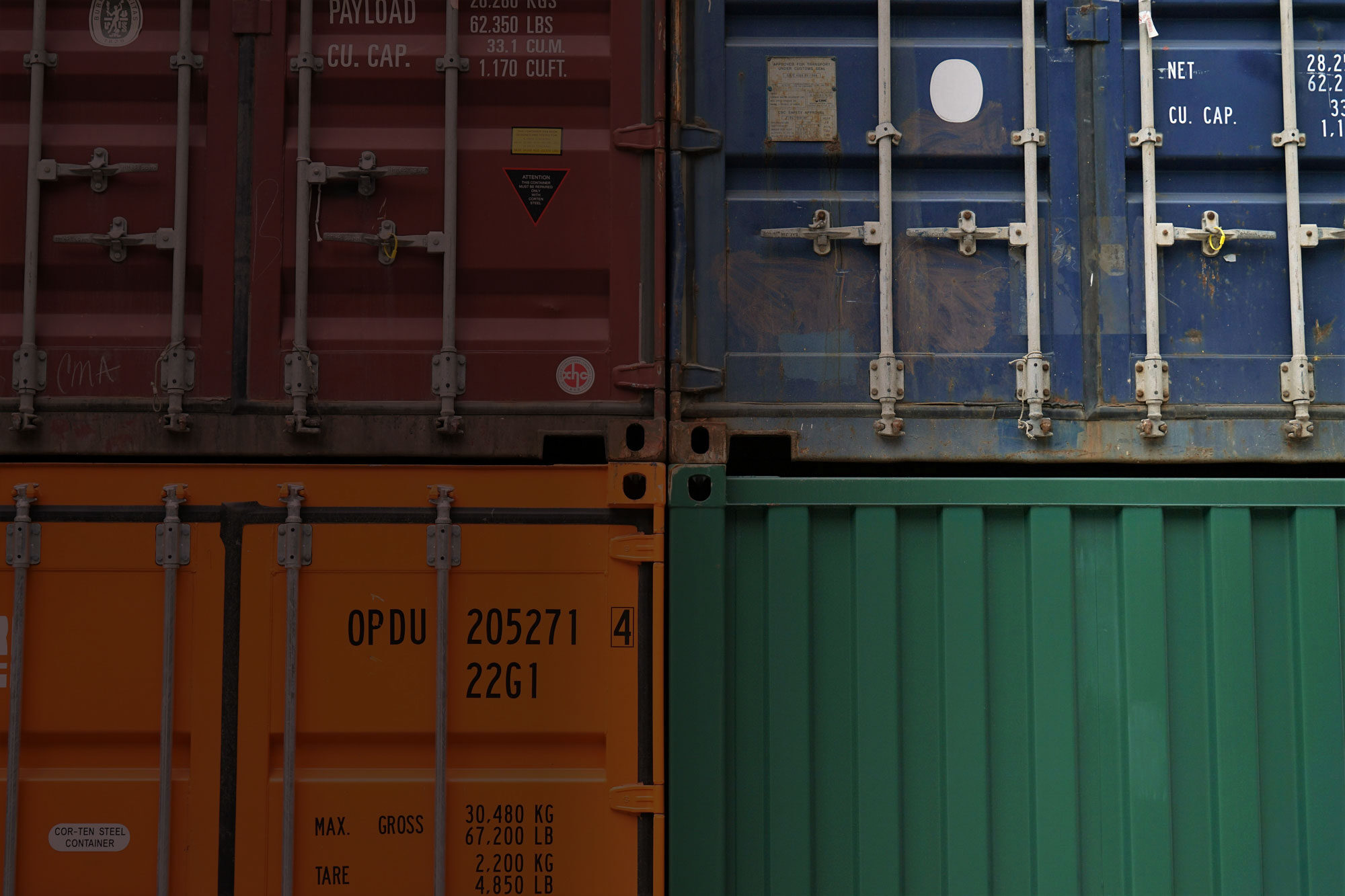Stacked colorful shipping containers in a port.
